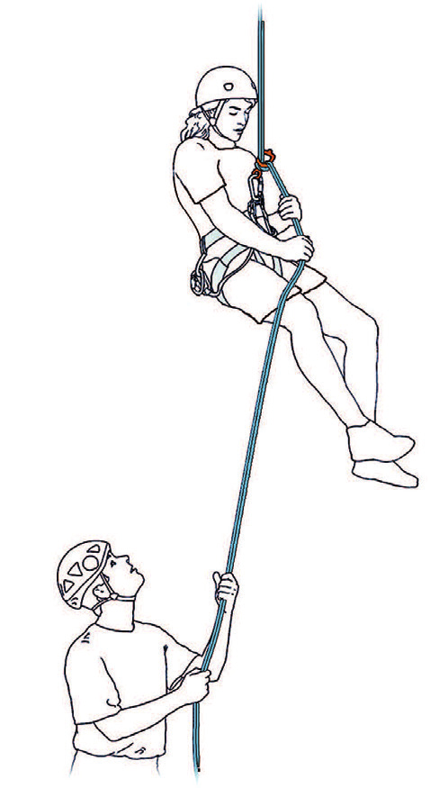 A rappeller descending while a second person on the ground manages the brake ropes (© Petzl)